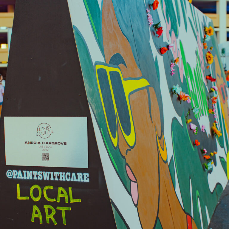 A close-up photo of artwork by Las Vegas artist Anecia Hargrove. The piece has a sign that indicates it's "Local Art"