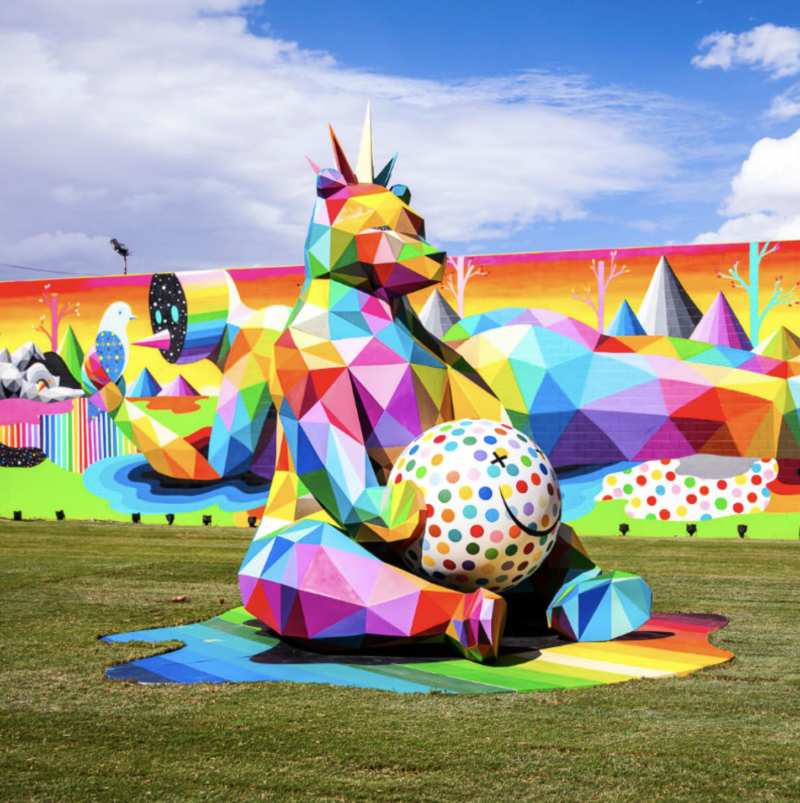 An abstract art installation by Okuda San Miguel featuring a colorful geometric bear.