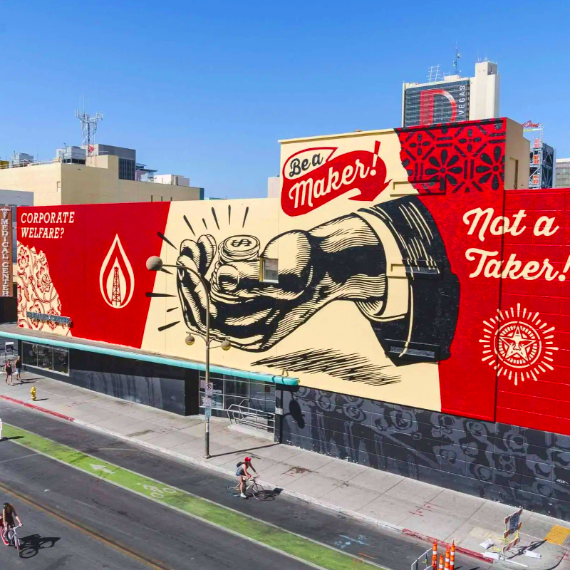 A mural by by Shepard Fairey featuring a hand holding coins and the words "Be a Maker, Not a Taker"