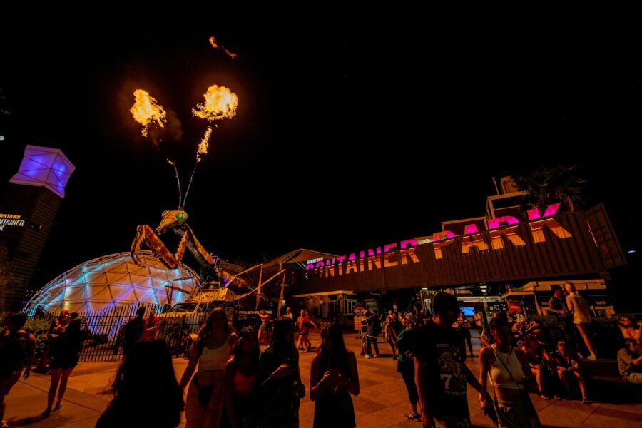 A night show in front of Container Park in Downtown Las Vegas, featuring a fire-breathing praying mantis sculpture.